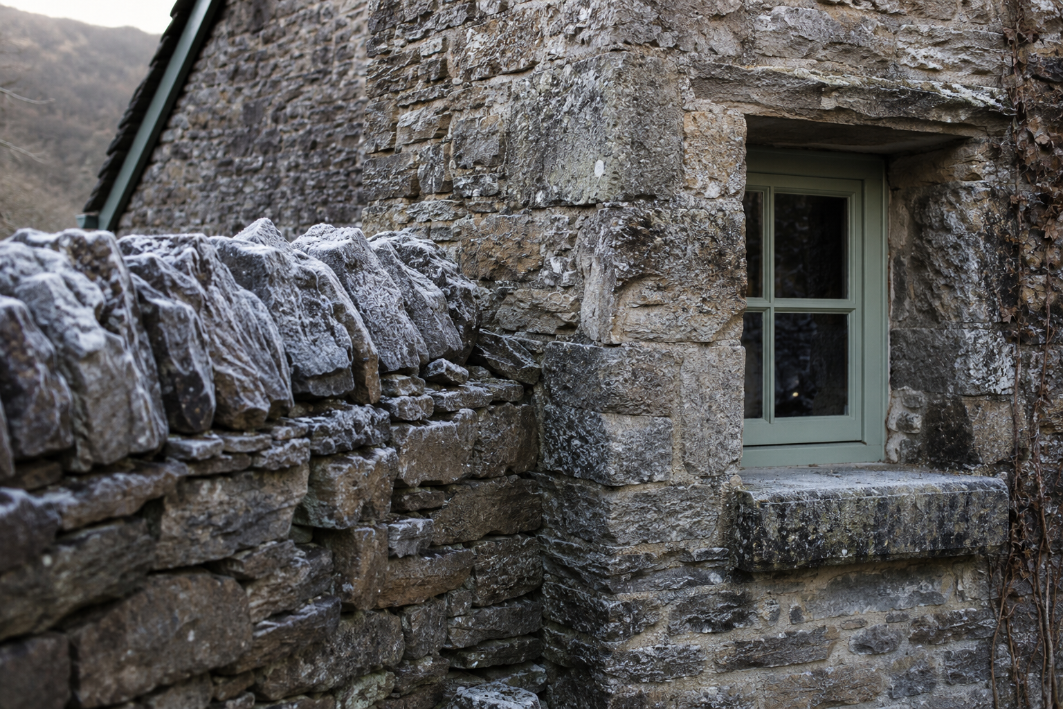 A thick stone wall and small window in a Derbyshire cottage interior